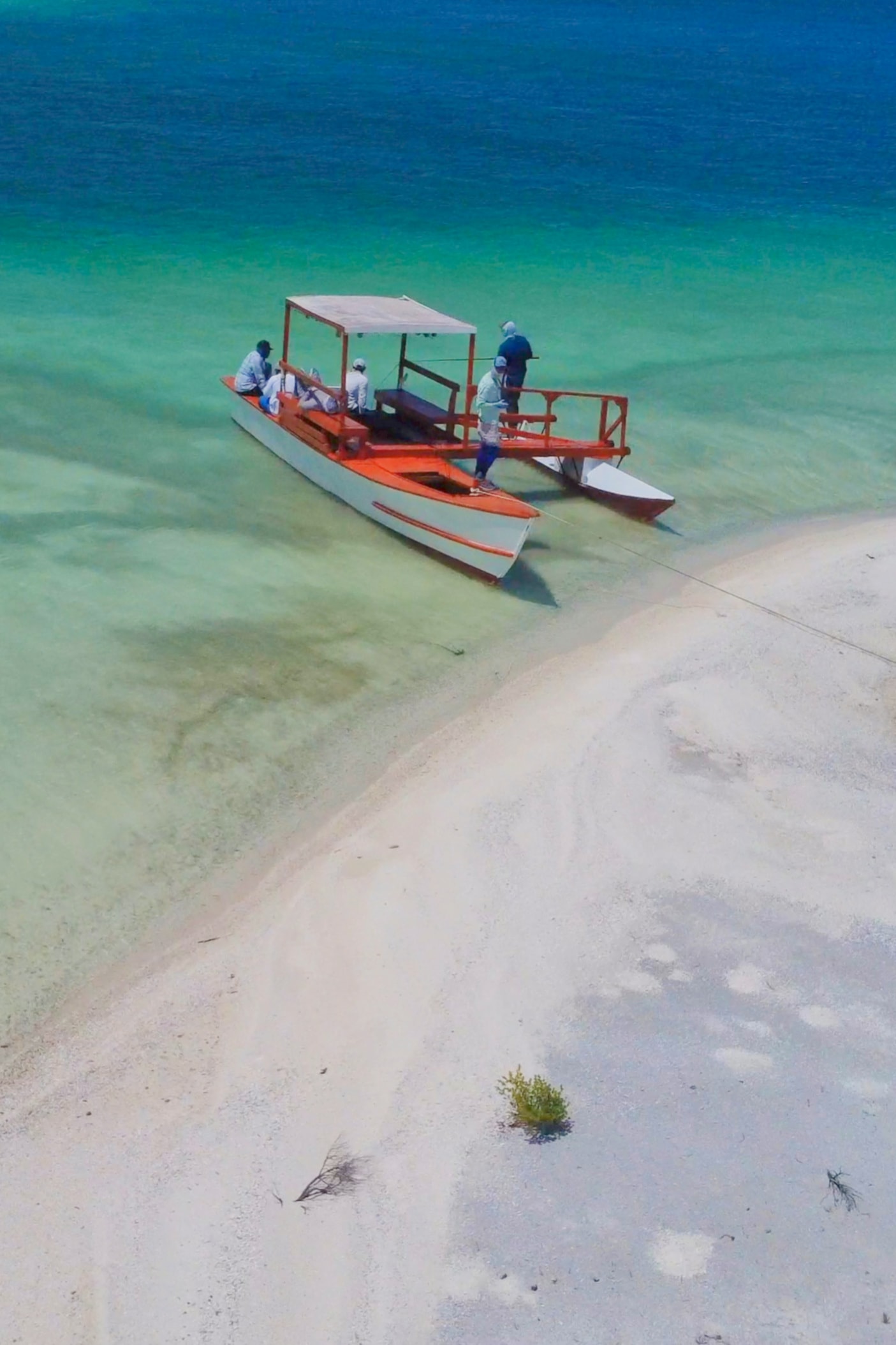 Outrigger boat on turquoise tropical flats South Pacific